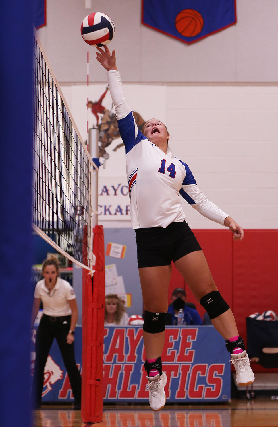 Braelyn Kozisek tips the ball over the center of the net